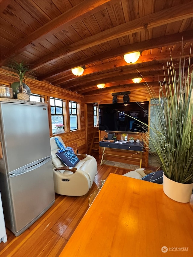 living room with beamed ceiling, hardwood / wood-style floors, and wood ceiling