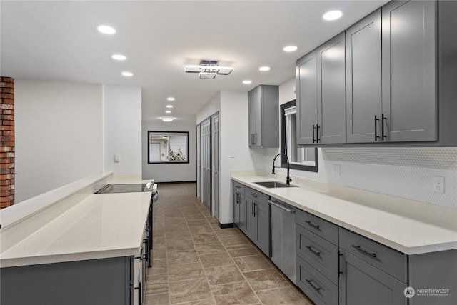 kitchen with stainless steel appliances, gray cabinets, and sink