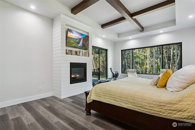 bedroom featuring hardwood / wood-style flooring, beamed ceiling, coffered ceiling, and a fireplace