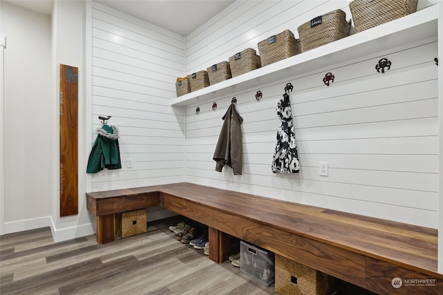 mudroom featuring wood walls and hardwood / wood-style flooring