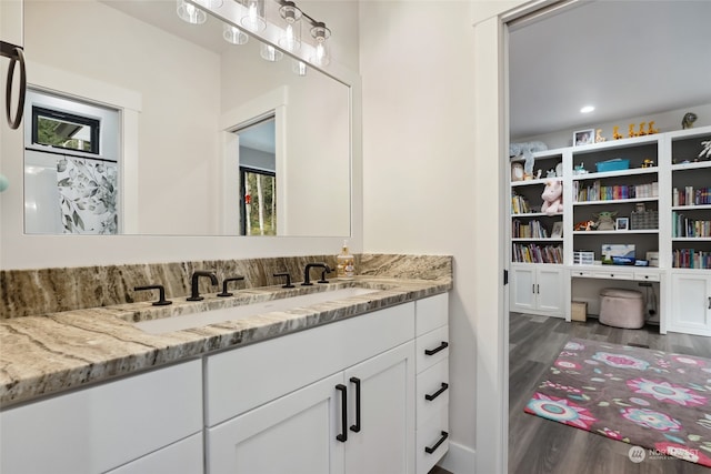 bathroom with vanity and wood-type flooring