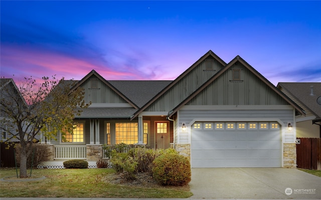 craftsman house with covered porch and a garage