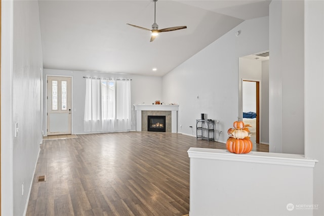 unfurnished living room with lofted ceiling, hardwood / wood-style flooring, and ceiling fan