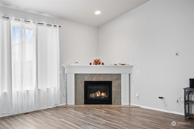 unfurnished living room featuring hardwood / wood-style flooring and a fireplace