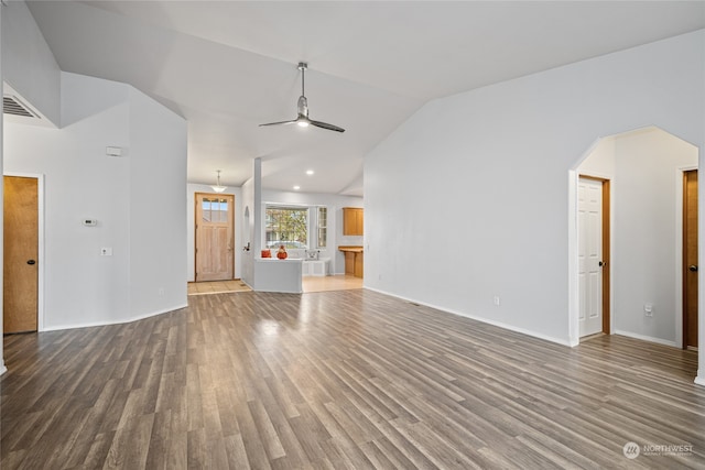 unfurnished living room with ceiling fan, vaulted ceiling, and hardwood / wood-style floors