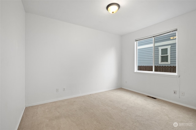 empty room featuring light carpet