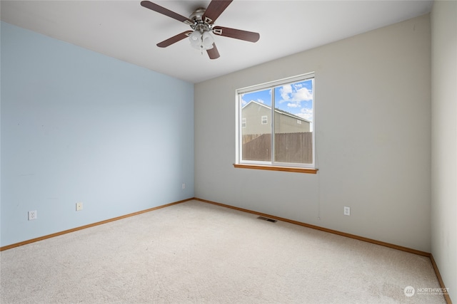 carpeted empty room featuring ceiling fan