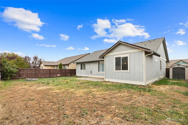 back of property featuring a storage unit