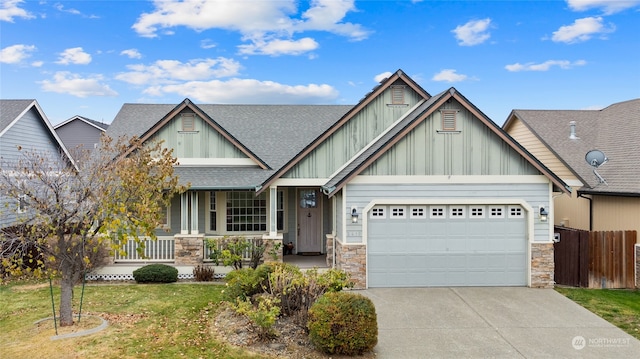 craftsman inspired home with covered porch, a garage, and a front lawn