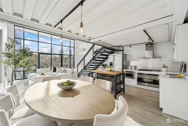 dining area featuring light wood-type flooring and sink