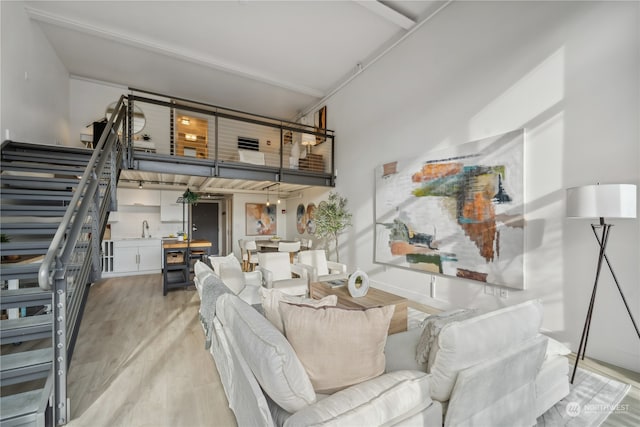 living room featuring sink and light hardwood / wood-style floors