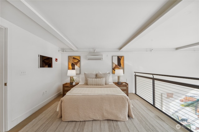 bedroom with an AC wall unit and beam ceiling