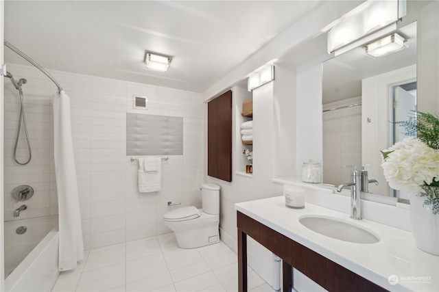 full bathroom featuring tile walls, tile patterned floors, vanity, shower / bath combo, and toilet