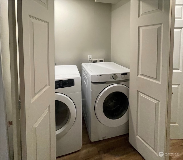 clothes washing area featuring dark wood-type flooring and independent washer and dryer