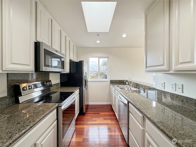 kitchen featuring white cabinetry, appliances with stainless steel finishes, sink, and dark hardwood / wood-style flooring