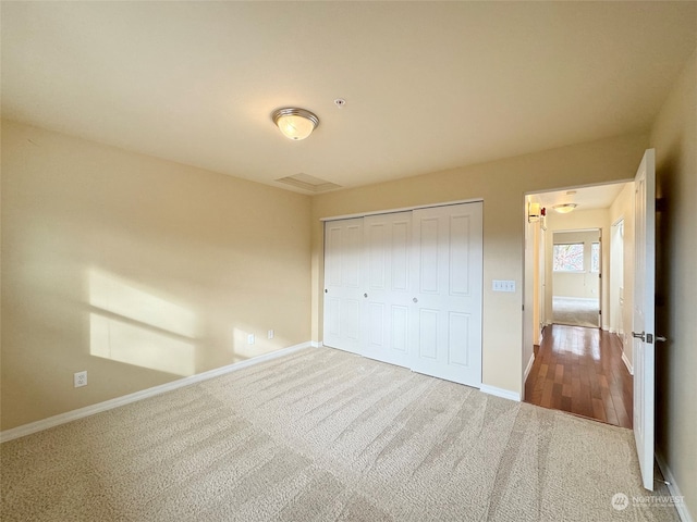 unfurnished bedroom with a closet and carpet