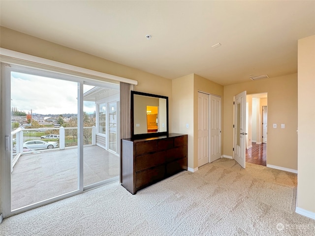 carpeted bedroom featuring access to exterior and a closet