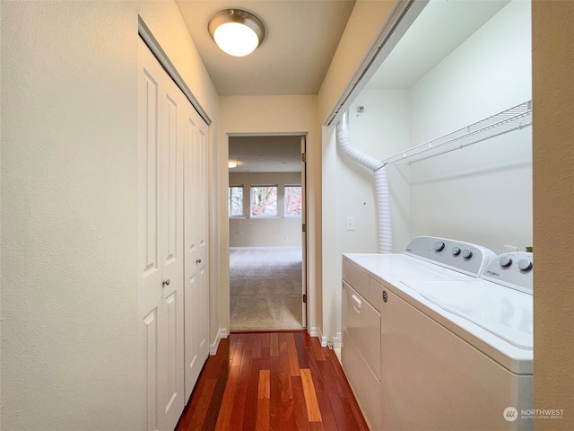 clothes washing area with dark hardwood / wood-style flooring and washer and dryer