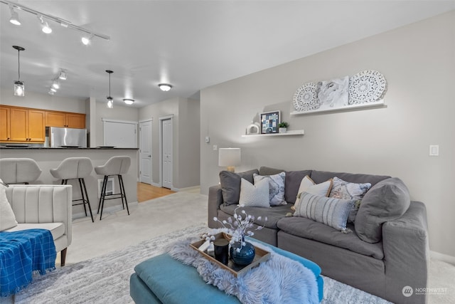 living room featuring light colored carpet and track lighting