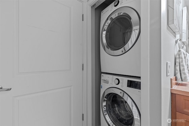 laundry room with stacked washer and clothes dryer