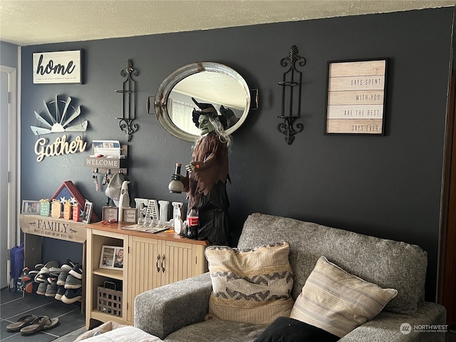 living area featuring a textured ceiling