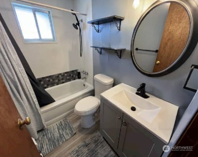 full bathroom featuring vanity, toilet, wood-type flooring, and shower / tub combo with curtain