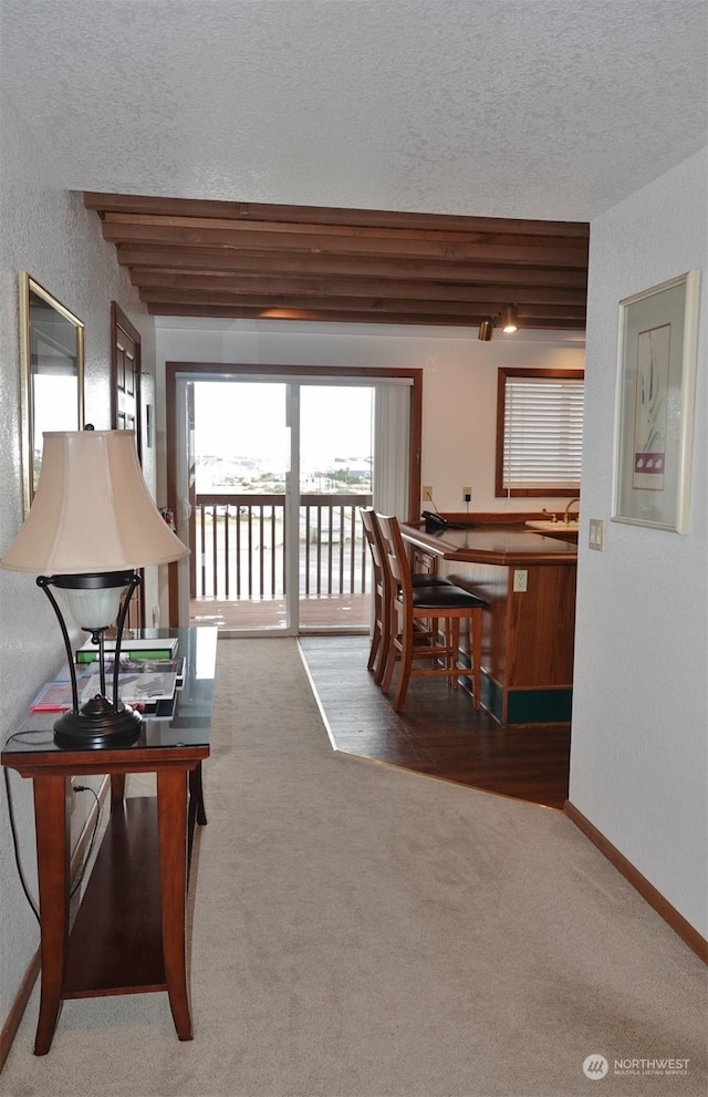 1399 Ocean Shores Blvd SW Unit 2N-E, Ocean Shores, WA 98569 - carpeted living area featuring a textured ceiling and a textured wall