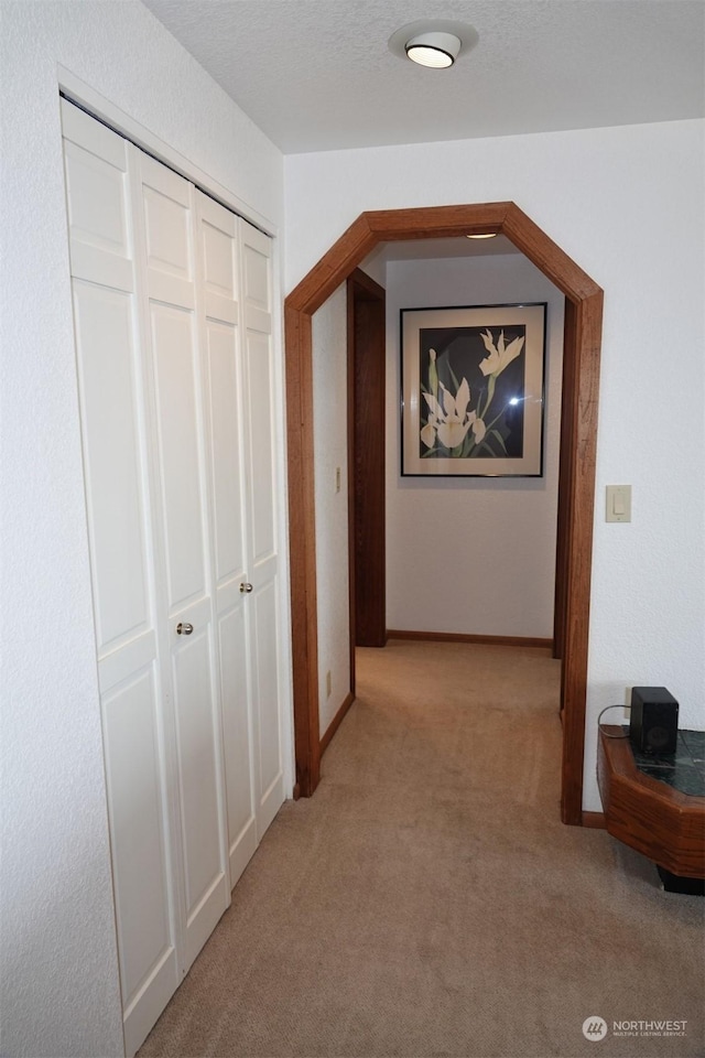 1399 Ocean Shores Blvd SW Unit 2N-E, Ocean Shores, WA 98569 - hallway featuring light carpet and baseboards