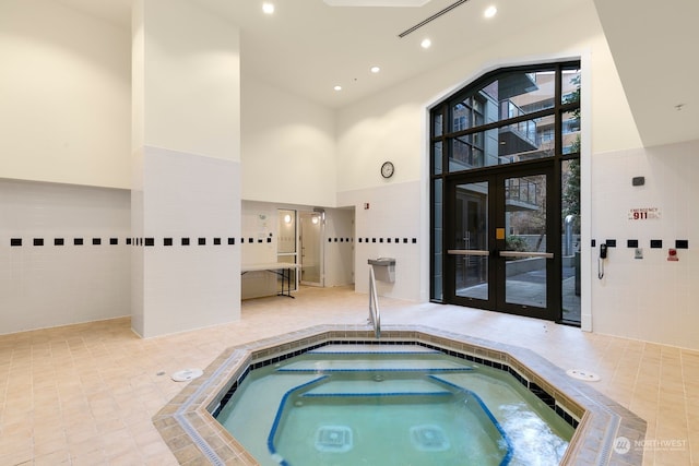 view of swimming pool with an indoor in ground hot tub