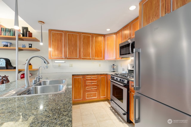 kitchen with light tile patterned flooring, stainless steel appliances, sink, and dark stone counters