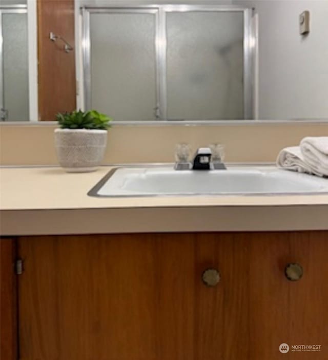 1810 S 118th Unit 401, Seattle, WA 98168 - bathroom featuring vanity and a stall shower
