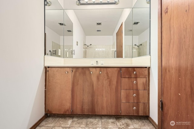 bathroom featuring a shower and vanity