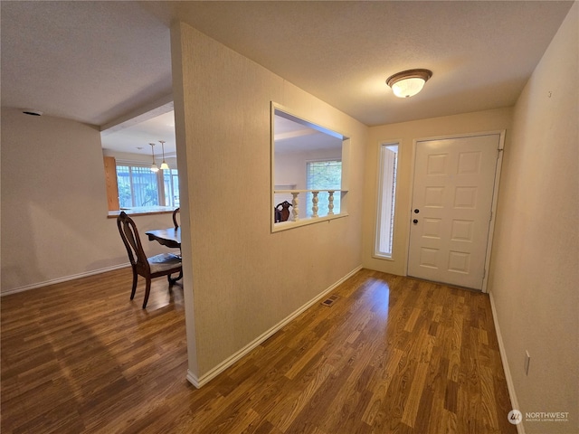 entryway featuring a textured ceiling and dark hardwood / wood-style floors