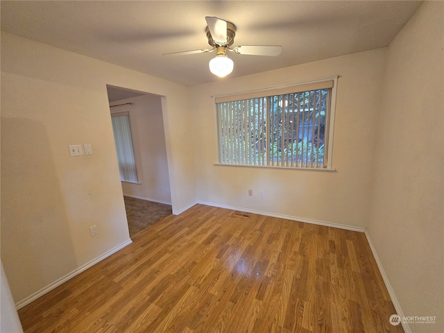 empty room with ceiling fan and hardwood / wood-style floors