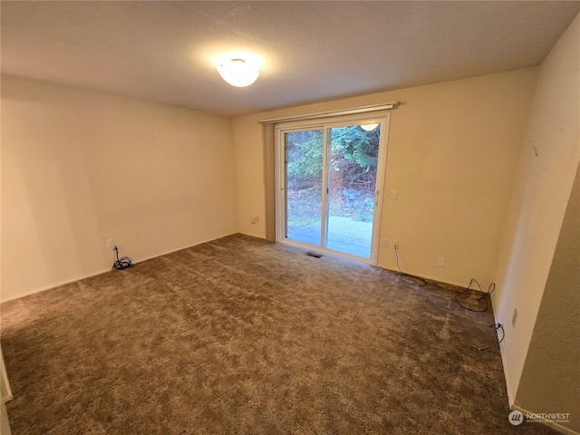 carpeted spare room with a textured ceiling