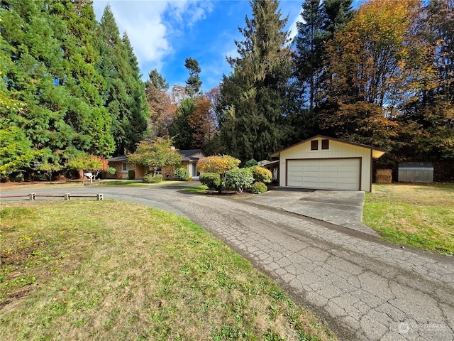 exterior space featuring a garage and an outbuilding