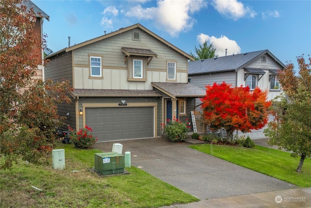 view of front of home with a front yard and a garage