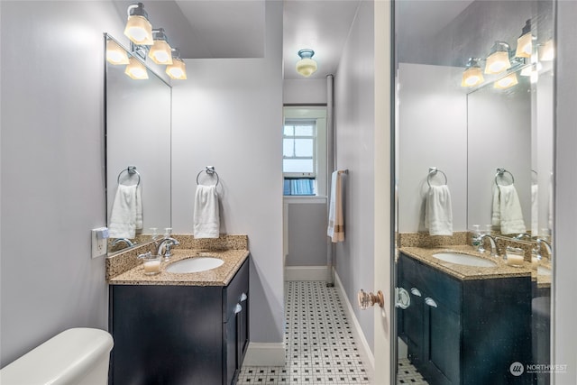 bathroom featuring vanity and toilet