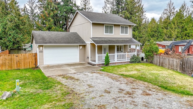 view of front property featuring covered porch, a garage, and a front lawn