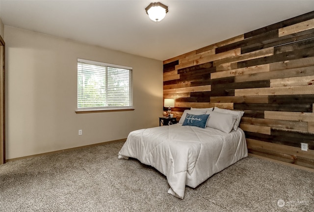 carpeted bedroom featuring wooden walls