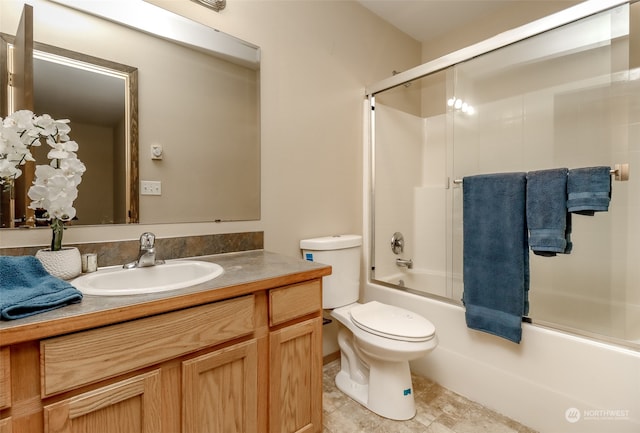 full bathroom with vanity, enclosed tub / shower combo, and toilet