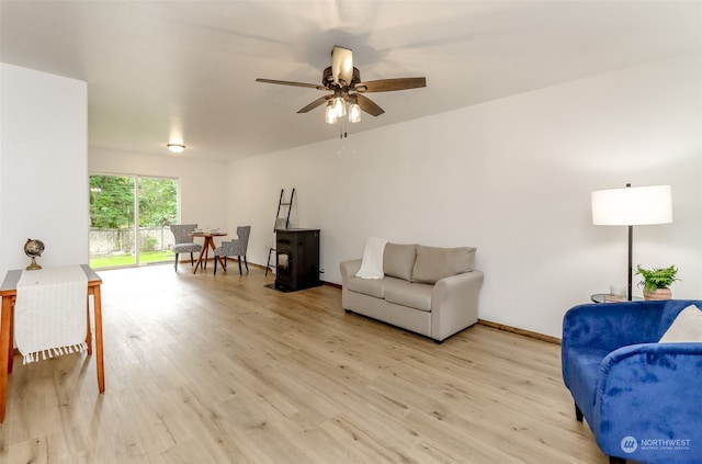 living room featuring light hardwood / wood-style flooring and ceiling fan