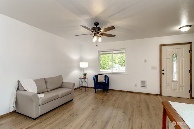 living room with light hardwood / wood-style floors and ceiling fan