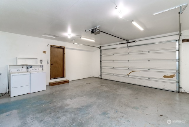 garage featuring a garage door opener and separate washer and dryer