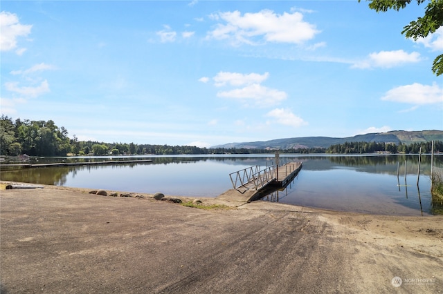 view of dock with a water and mountain view