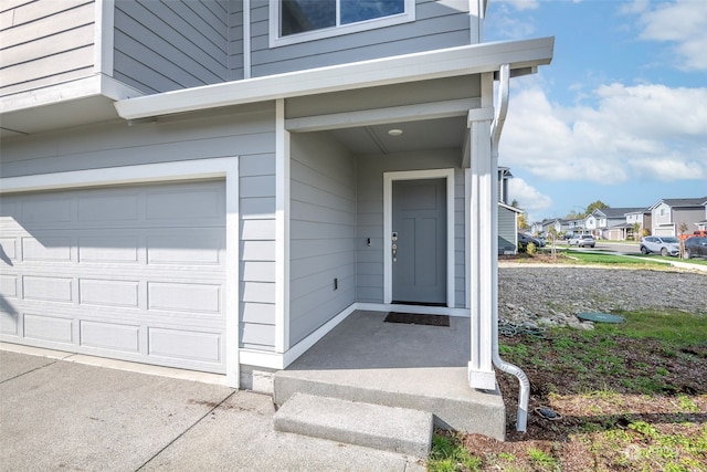 view of exterior entry with a garage