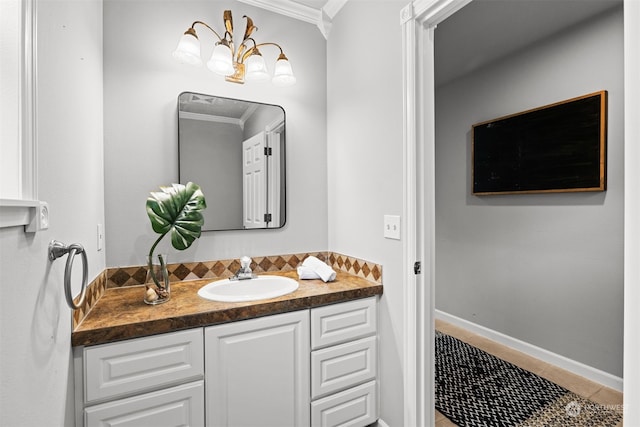 bathroom with vanity, ornamental molding, and tile patterned flooring