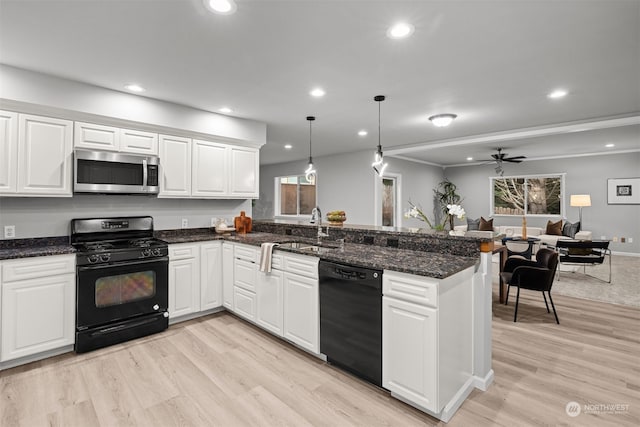 kitchen featuring white cabinetry, black appliances, and pendant lighting