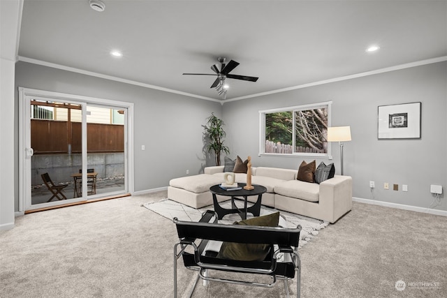 living room featuring crown molding, light colored carpet, and ceiling fan