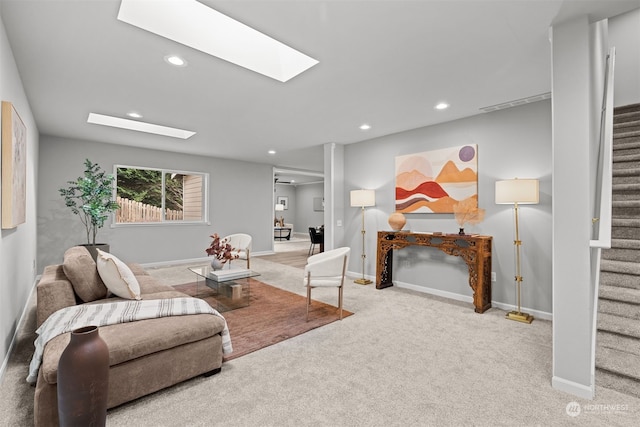 carpeted living room with a skylight